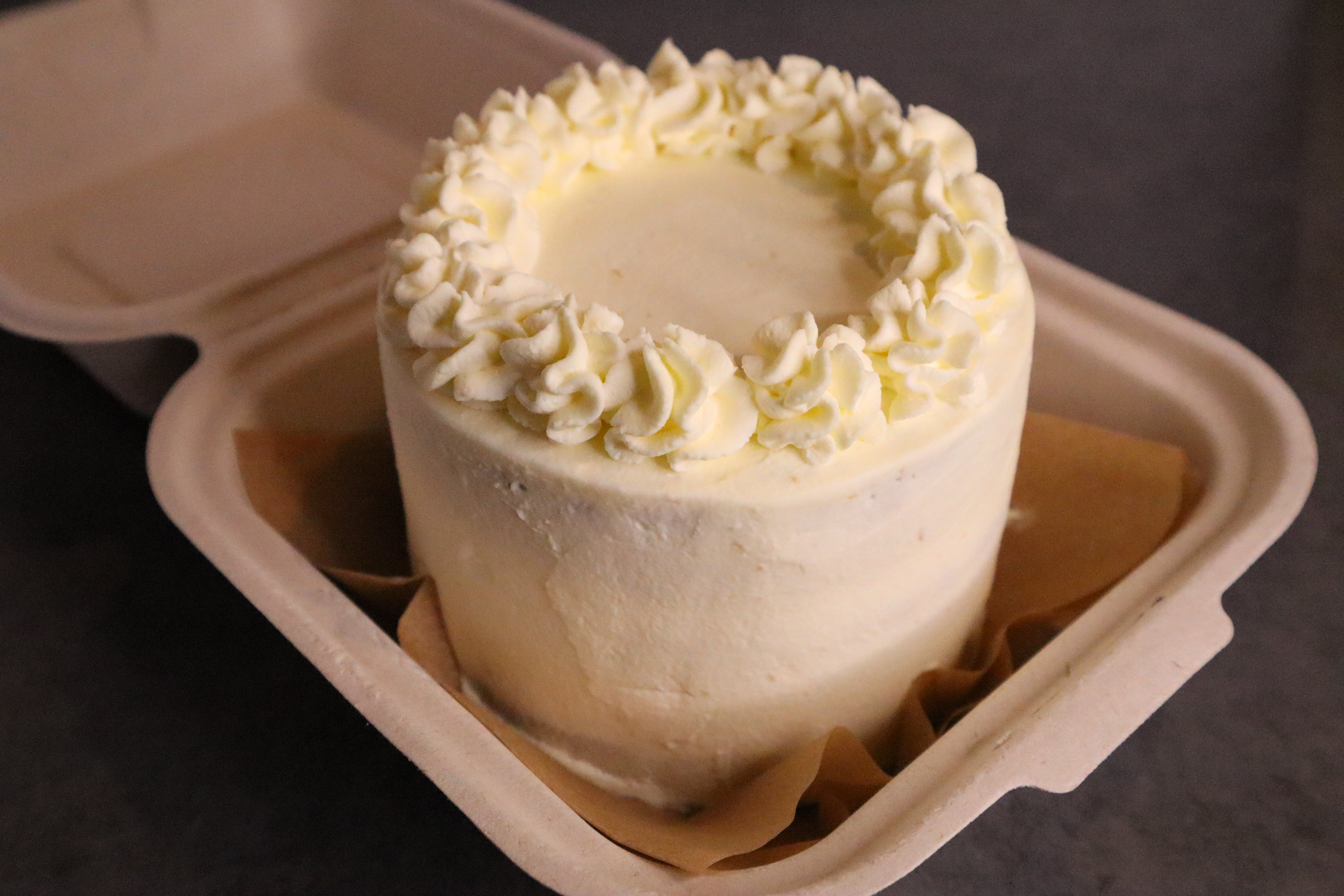 Simple white minimalist cake with a ring of white frosting on top